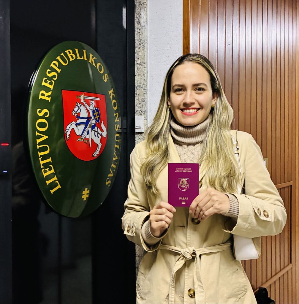 Client holding her Lithuanian passport at the Lithuanian Consulate in São Paulo